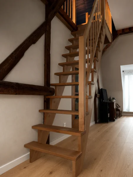 Naturfarbene Holztreppe mit Holzhandlauf und Geländerstäben